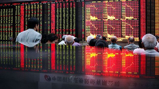 Investors monitor stock prices at a securities exchange in Shanghai on May 7, 2009