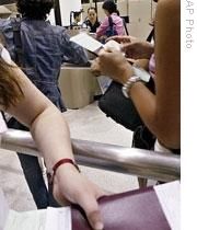 Travelers show their documents to immigration officers at Los Angeles International Airport